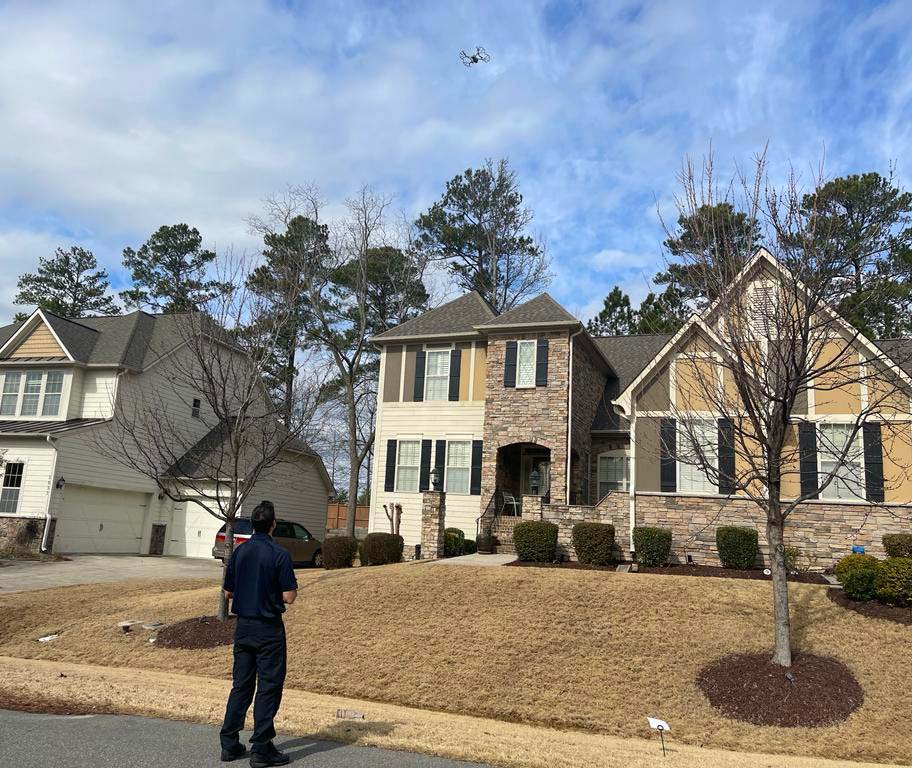 Home Inspector Ali Nakhaie using an aerial drone to do a roof inspection 